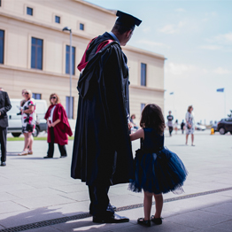 Man and child at graduation 