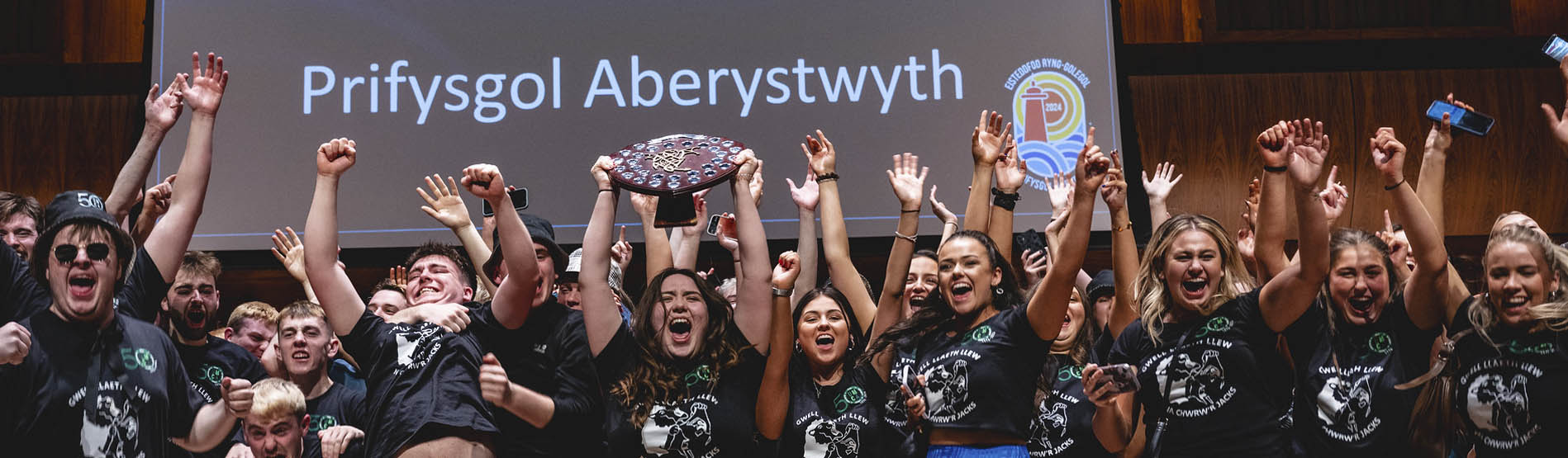 Aberystwyth University students hold up winning sheild