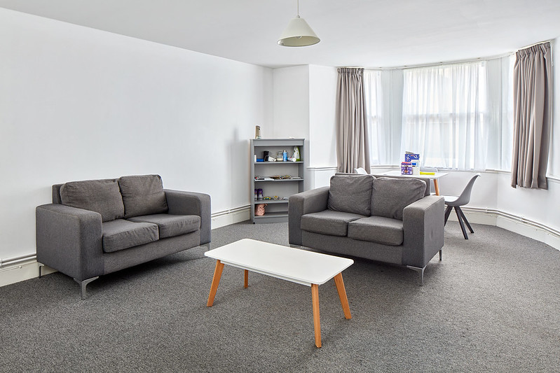 Photograph of furnished living room in a family flat.