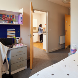 An image of a student in the kitchen in a 1 bedroom flat on Bay Campus.