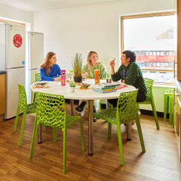 An image of a group of students chatting in a kitchen in Singleton Campus accommodation