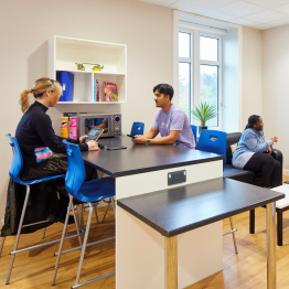 An image of a group of students in a kitchen in accessible student accommodation on Bay Campus.