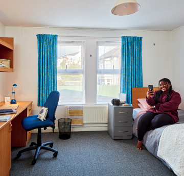 An image of a student in a room in student accommodation in Beck House.