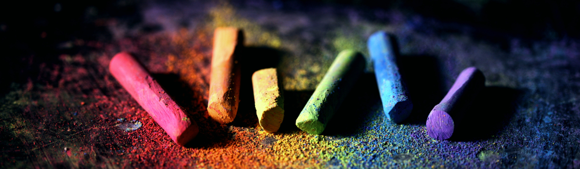 A picture of different coloured chalks, resting on a black background. (Pexels | Sharon McCutcheon)