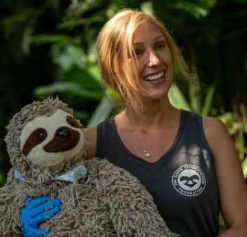Lady in a conversation sanctuary holding a sloth