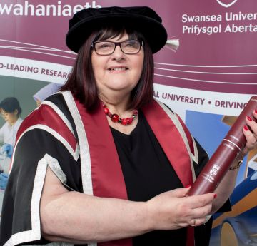 Lady in cap and gown and scroll 