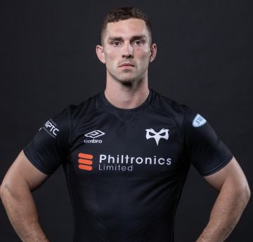 Man in Ospreys rugby kit posing for the camera