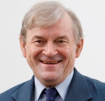 Man wearing a suit smiling at the camera