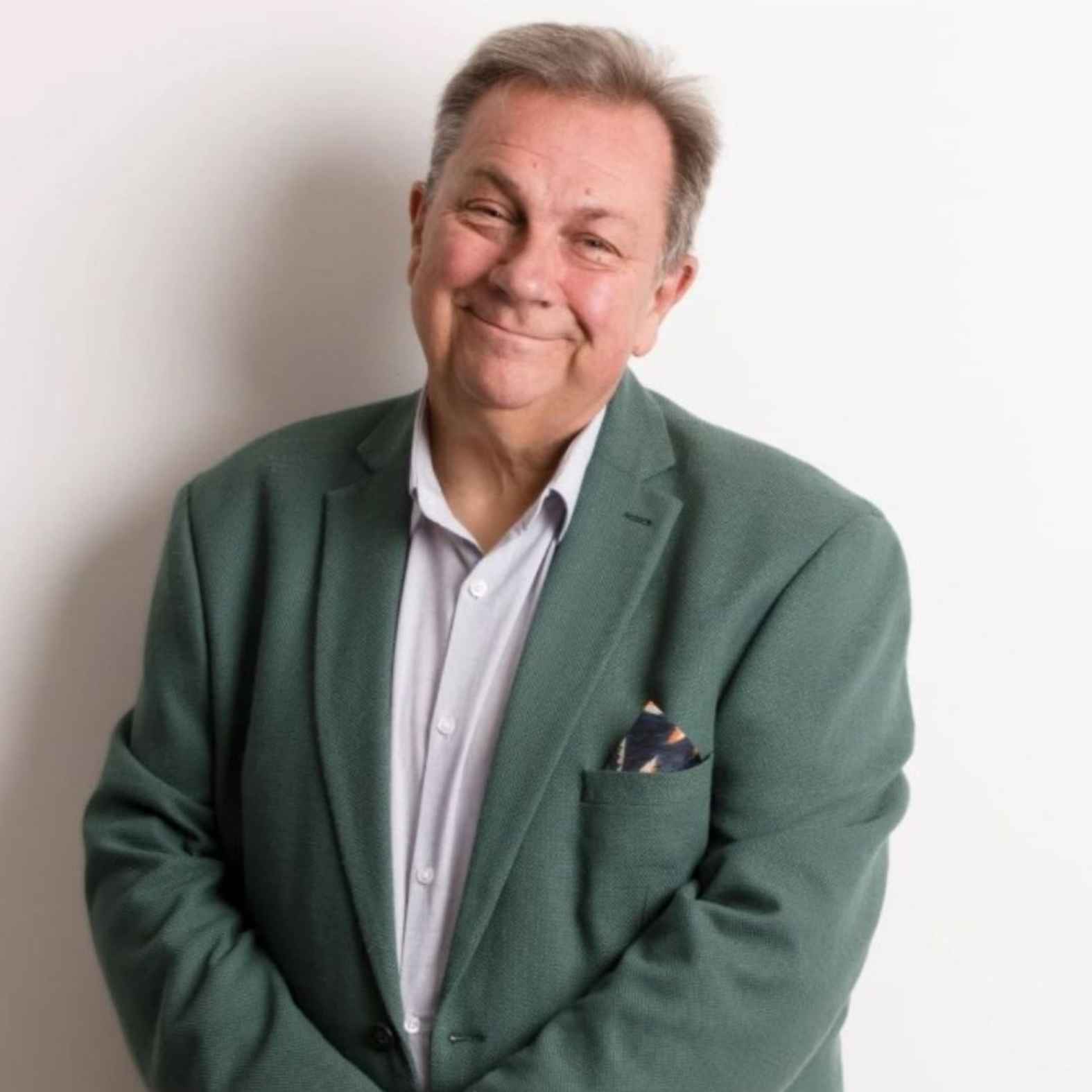 Man wearing a suit, smiling at the camera