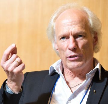 Man raising his hand whilst speaking