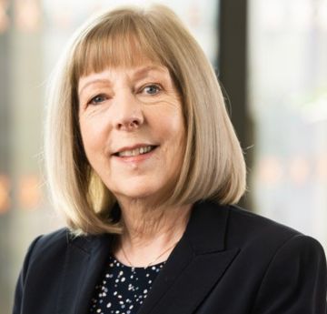 Lady dressed smartly smiling at the camera