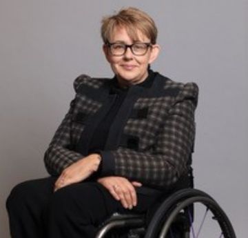 Lady in a smart suit smiling at the camera