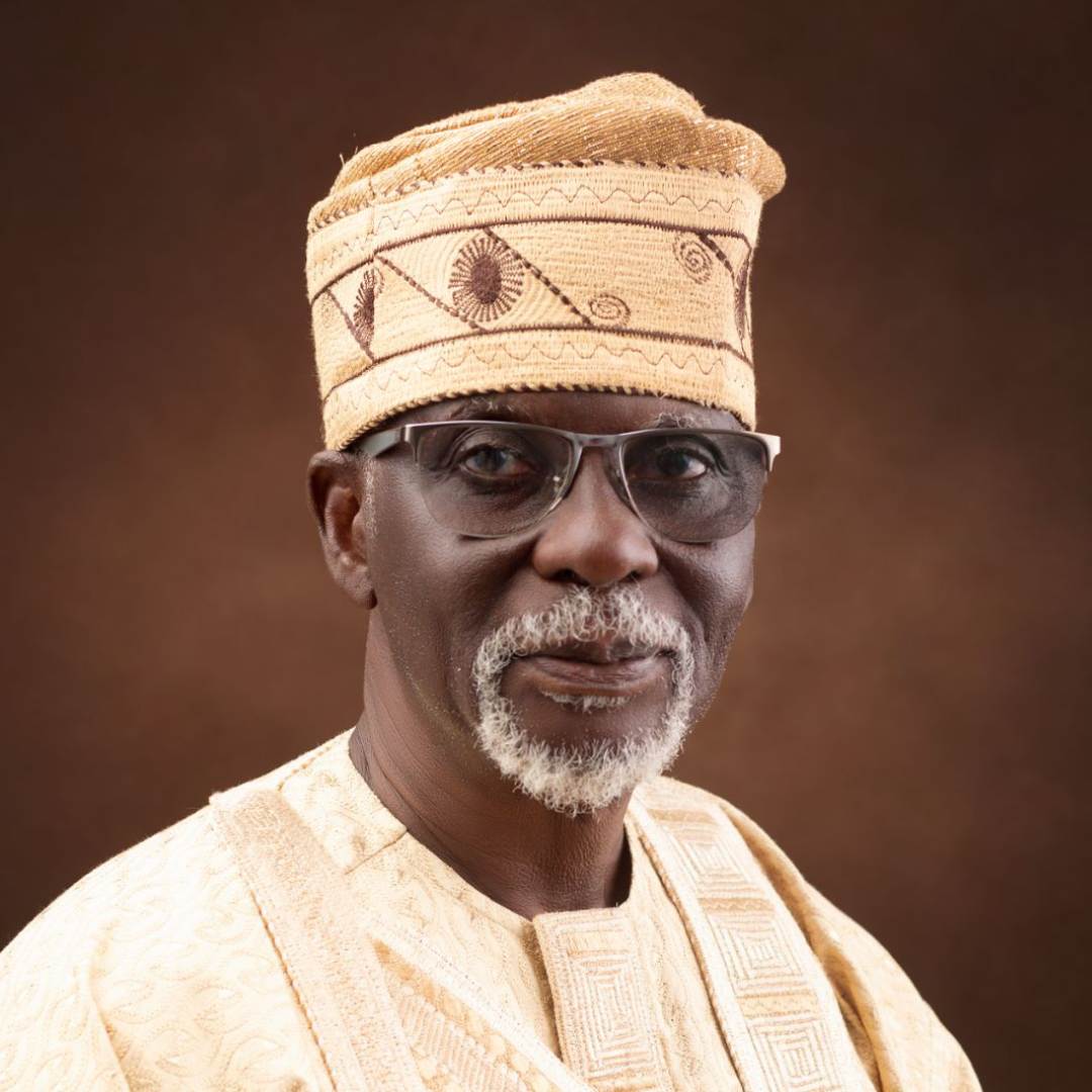 Man wearing traditional Nigerian dress smiling at the camera