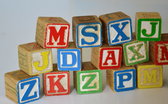Stacked wooden letter blocks.
