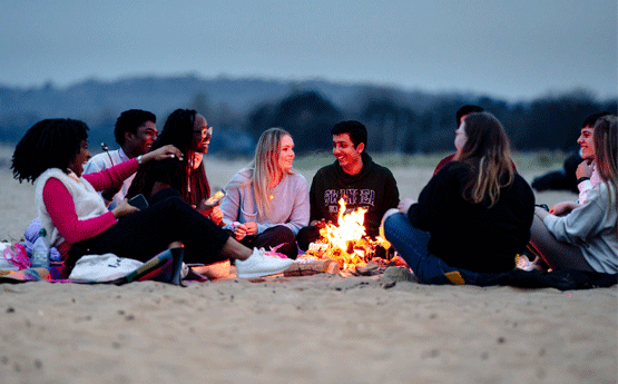 Image shows a group of students on Swansea Bay taking a selfie together.