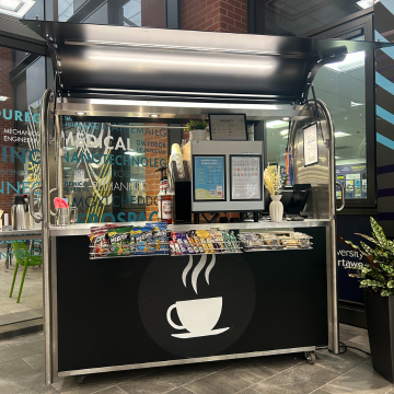 cup of coffee cart in engineering central, chocolate bars displayed along the front
