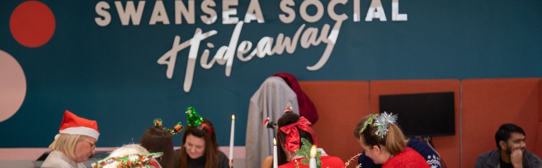 The hideaway at christmas time, backs of heads with christmas headwear 