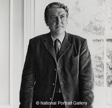 A black and white photo of Kingsley Amis