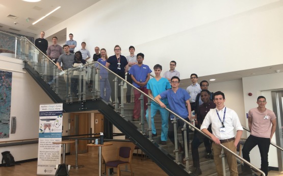 Final year cohort of medical students stood on a staircase.