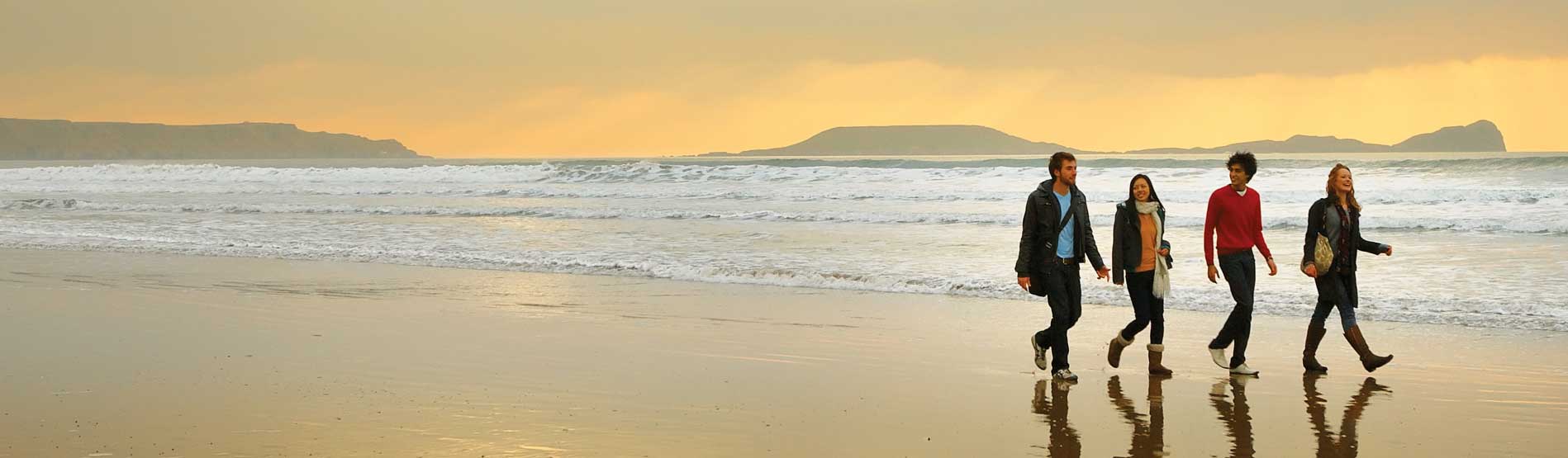 students walking on the beach