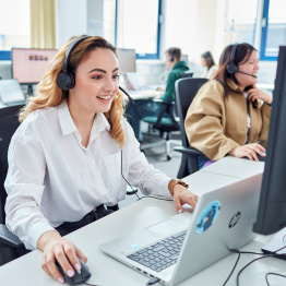 An image of two Clearing helpline staff taking calls.