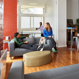An image of students sitting in the communal area in student accommodation on Singleton Campus.