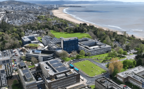 Birdseye view of campus and the sea. 