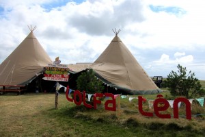 two canvas tents on the eisteddfod field with bunting reading Lolfa Len