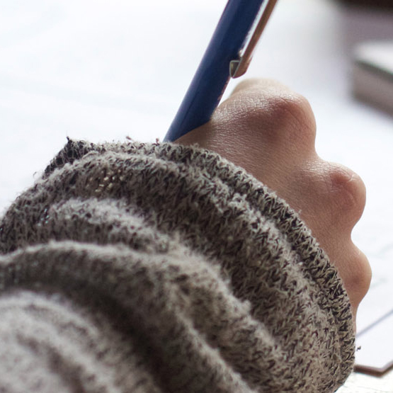 Image of a hand holding a pen 