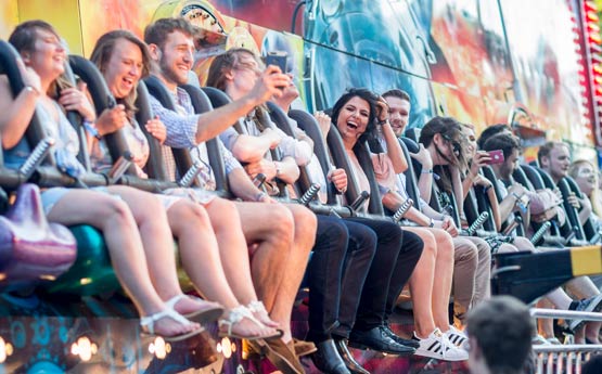 Students on a fairground ride at the summer ball