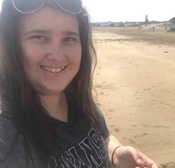 A selfie of Lizzie Alcock on the beach at Swansea University