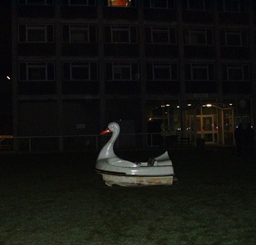 A photo of the giant swan boat outside Sibly Residences at night