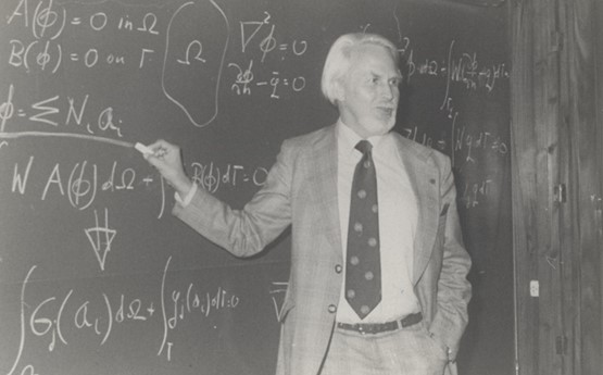 Professor Olek Zienkiewicz stood in front of a blackboard with a series of equations written in chalk. 