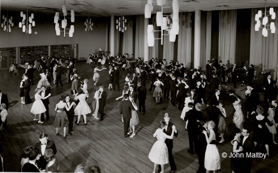 Black and white photo of students dancing in College House.