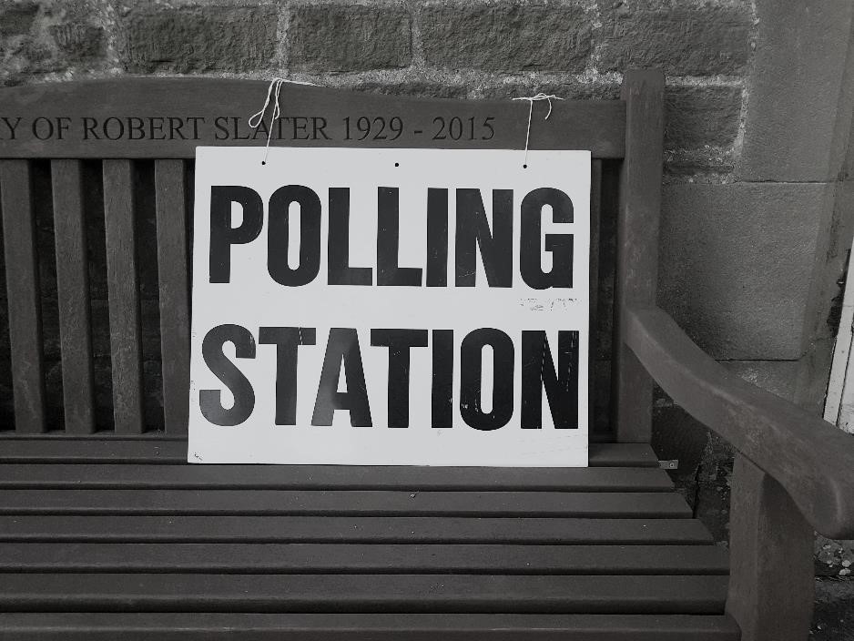 'Polling station' placard on a bench. 