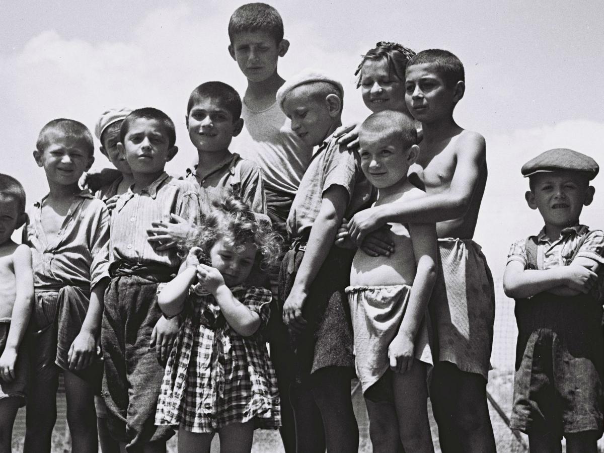 Holocaust Orphans stood in a field. 