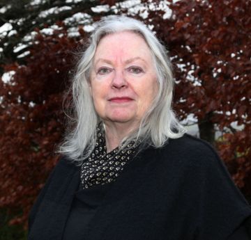 Lady outside smiling at the camera