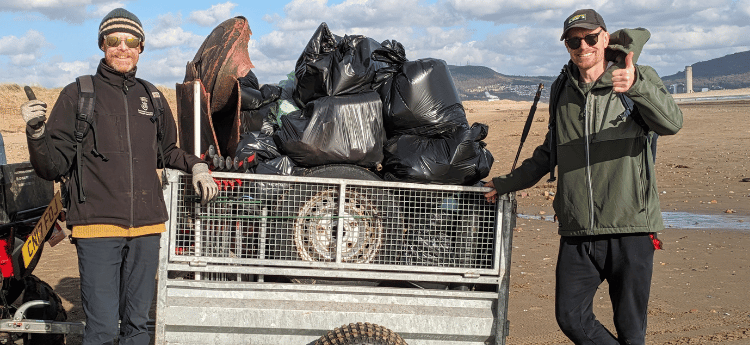 Ben our Biodiversity Officer and Chris from Zombie Plastics with a trailer full of waste collected during a beach clean