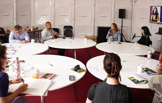 Elaine Canning and Yasmin Zaher in the 'Writer's at Work' tent with several writers at desks