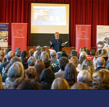 photo of an audience full of people listening to author, Michael Rosen