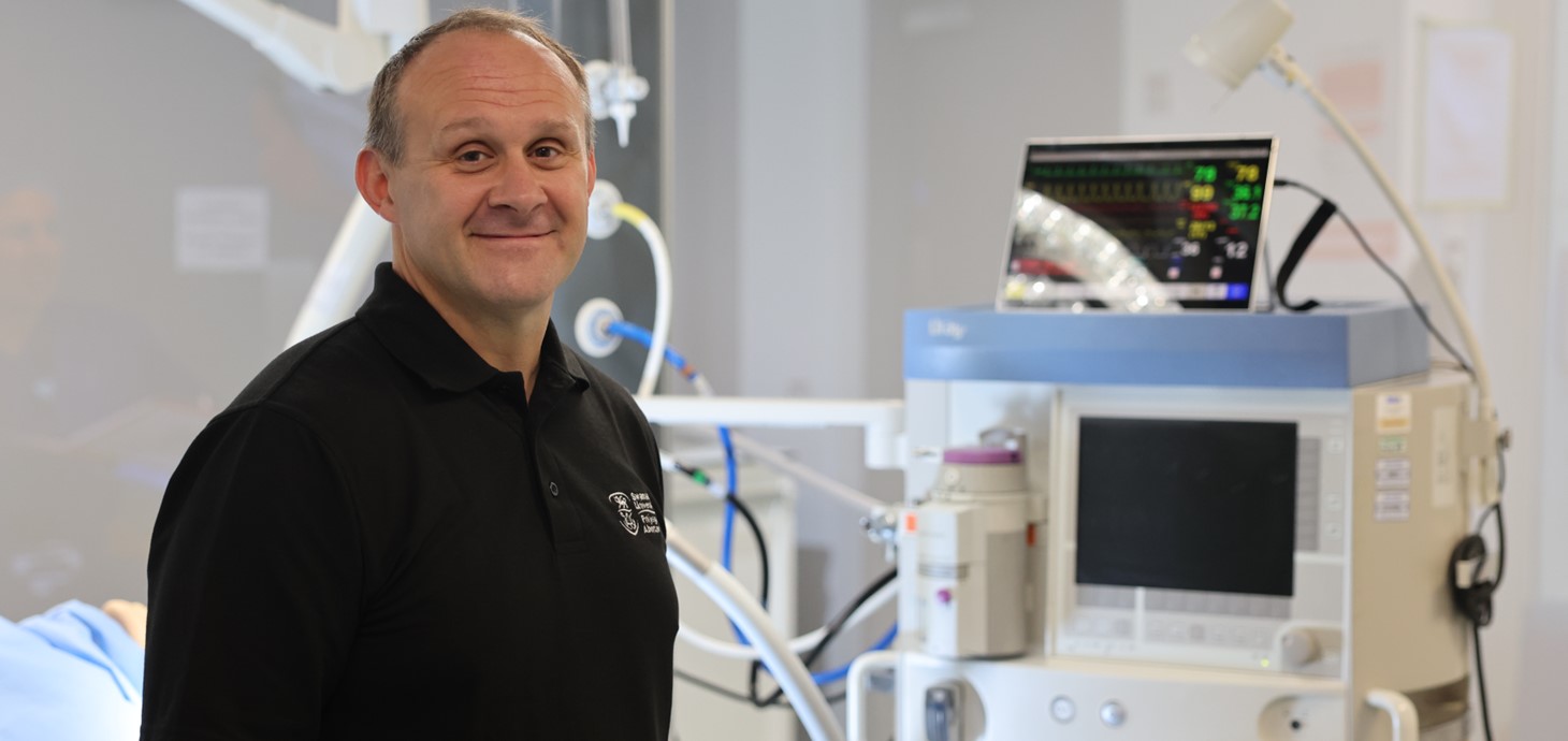 Dyn yn defnyddio sgriwdreifer i atgyweirio peiriant