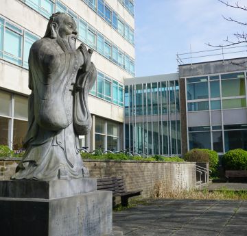 The statue of Confucious looking over the Vivian Tower Pool - Singleton Park Campus