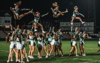 Cheerleading squad performing during a half time performance at the rugby fixture. 