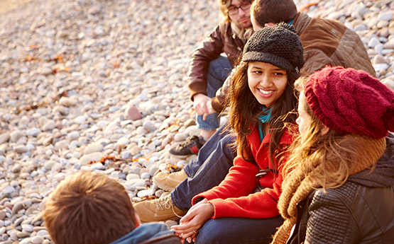 Students on a beach socialising.