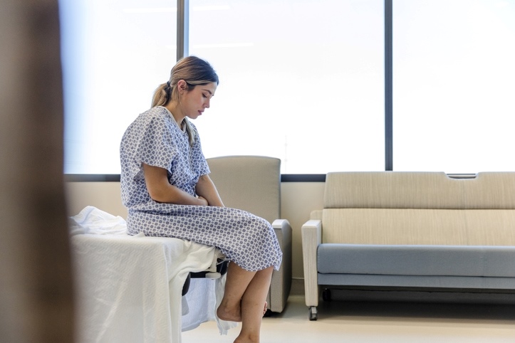 Woman sat on hospital bed
