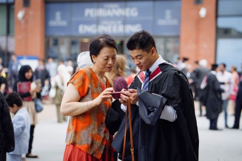 student at graduation with parent 