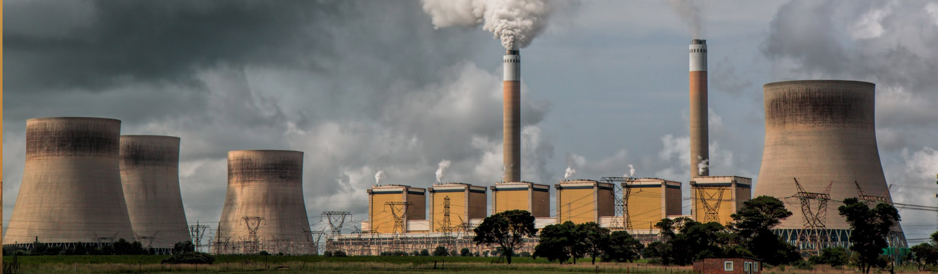 A series of industrial chimneys exhausting gases