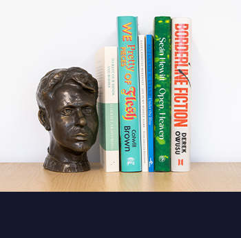 Image of bookshelf with the 6 shortlisted books and bust of Dylan Thomas