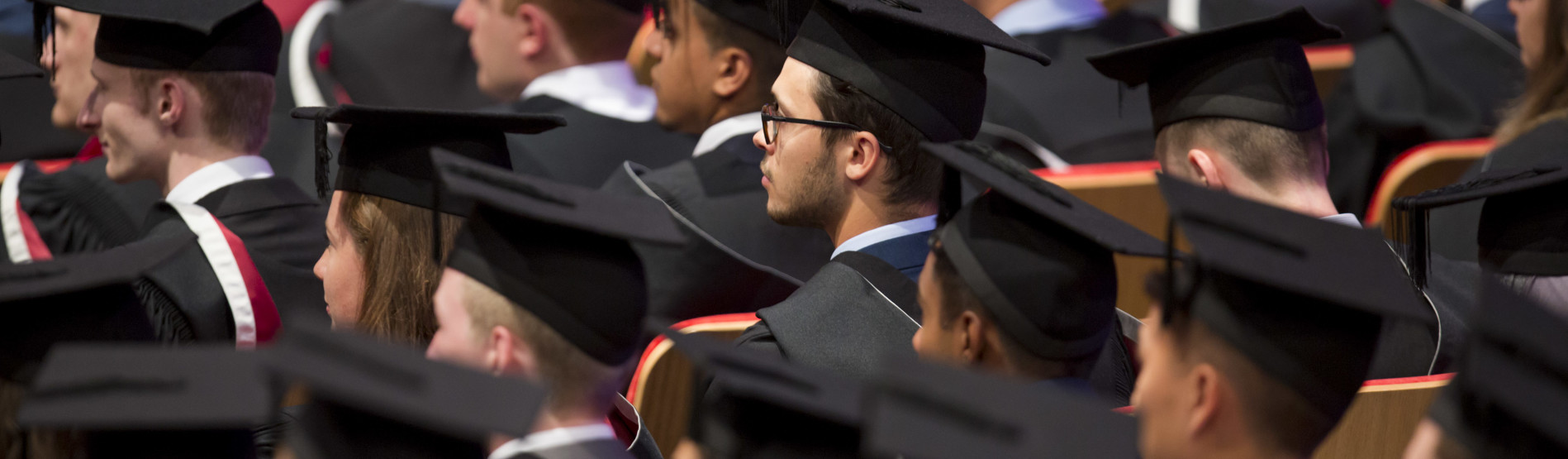 graduating student smiling on campus