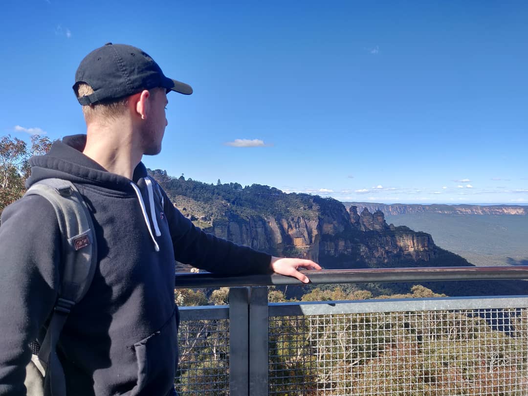 student standing in front of coastline